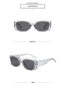 Detailansicht der kristallgrauen Sonnenbrille mit Bügeln in Rautenstruktur und dunklen Gläsern