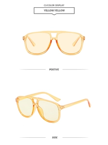 Close-up of yellow transparent aviator sunglasses with retro double bridge design