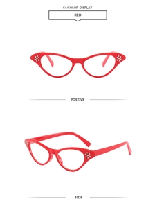 Detail view of red cat-eye sunglasses featuring silver rhinestone accents on side frames