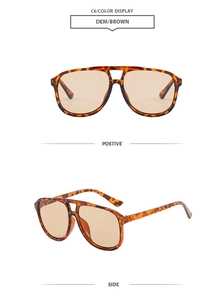 Detail view of tortoiseshell double-bridge aviator sunglasses with brown gradient lenses