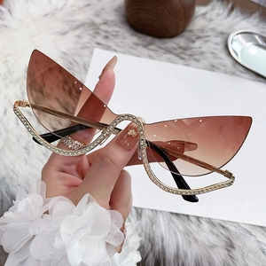 Lunettes de soleil œil de chat sans monture avec cadre doré en strass et verres bruns