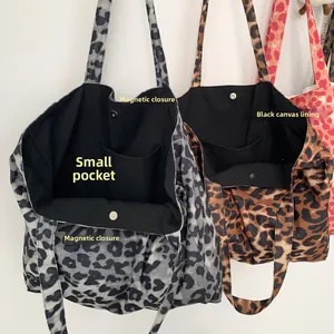 Detail of magnetic buckle closure and inner canvas lining of leopard print tote bag