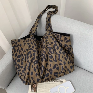 Close-up of leopard print corduroy tote bag featuring metal magnetic buckle closure