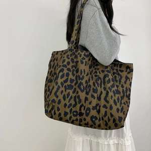 Close-up of leopard print tote bag fabric and large capacity design on white background
