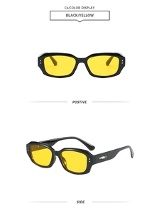Detail view of black square frame sunglasses with yellow lenses and silver accents