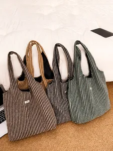 Close-up of herringbone pattern tote bags in brown, khaki, black and green colors