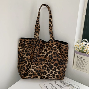 Detail shot of the textured leopard print corduroy tote bag in a stylish Korean setting