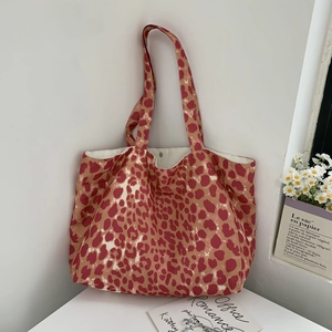 Detail of pink leopard print canvas tote bag with magnetic metal clasp and white lining