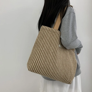 Detail showing the ATRY brand label and chevron wool pattern on a large tote bag