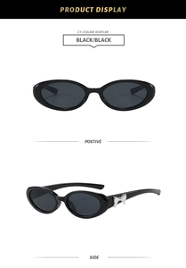 Détail de lunettes de soleil œil-de-chat ovales avec nœud argenté sur branche