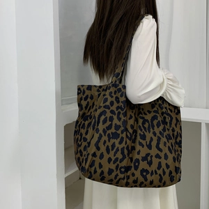 Detail showing the brown leopard print texture on a large canvas tote shoulder bag