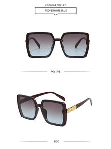 Detail view of square sunglasses with dark red frames, blue gradient lenses and gold hinges