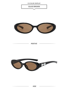 Détail de lunettes de soleil ovales avec verres bruns et nœud argenté sur les branches