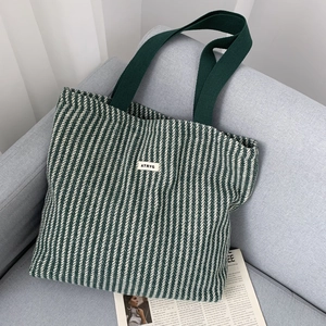 Deep green and cream V-stripe knit tote bag with wide handles for daily commute