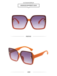 Detail view of square orange sunglasses with gradient gray lenses and textured temples