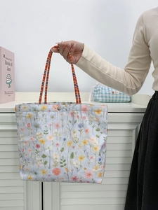 Blue floral embroidered canvas bucket tote bag with colorful woven handles for daily use