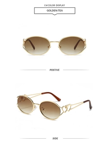 Detail view of oval metal sunglasses featuring hollow heart decoration and tea lenses