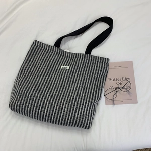Detailed close-up of large chevron-patterned tote bag with black strap and ATRYG logo label