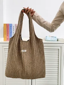 Detail of wool tote bag with herringbone pattern and ATRYG logo for autumn styling