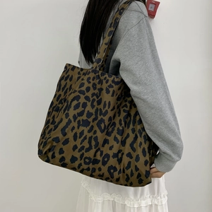 Large leopard print canvas tote bag for women showing spacious shoulder carry design