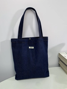 Deep blue denim canvas tote bag with ATRYG label and metal snap button for commute