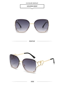 Detail of rimless square sunglasses with gold heart temples and grey gradient lenses