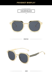 Detail view of golden irregular metal frame sunglasses with dark lenses and side motifs
