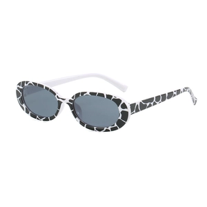 Classic oval frame sunglasses with retro black and white cow print and dark grey lenses