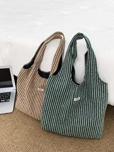 Close-up of knit tote bags featuring herringbone pattern and minimalist ATRYG fabric labels