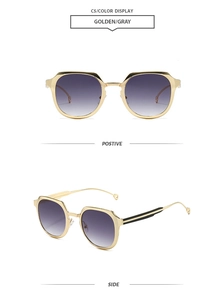 Detail of golden geometric sunglasses with gray gradient lenses and metallic temples