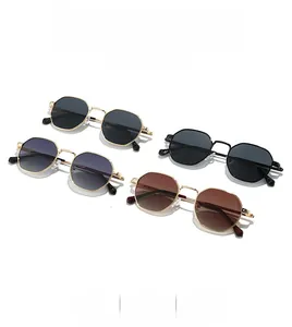 Close-up of polygon metal sunglasses in gold and black frames with various tinted lenses