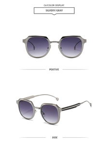 Detail view of silvery metal frames and purple gradient lenses on retro sunglasses