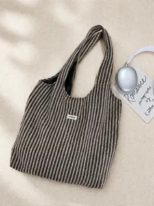 Detail of herringbone woven tote bag with ATRYG label and spacious black interior lining
