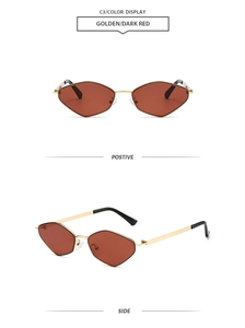 Detailed view of irregular pentagonal sunglasses with golden metal frame and dark red lenses