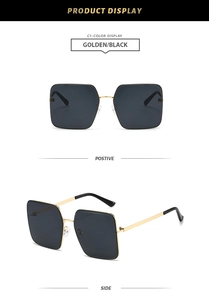 Classic square oversized sunglasses with golden metal frame and black lenses in detail view