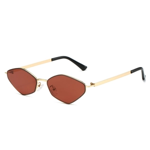 Irregular polygon sunglasses with gold metal frame and amber lenses on white background