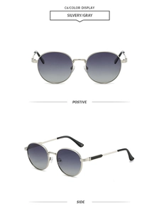 Detail view of oval retro silver metal sunglasses with gray gradient lenses and side profile