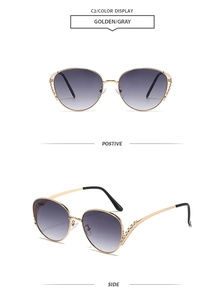 Detail of metal cat-eye sunglasses with rhinestone edges and gray gradient lenses