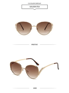 Detail of oversized gold metal sunglasses with woven hollow temples and tea gradient lenses