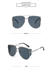 Detail view showing front and side profile of silver double-bridge metal aviator sunglasses