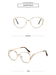 Detail view of gold metal oversized sunglasses with rhinestones and tortoiseshell tips