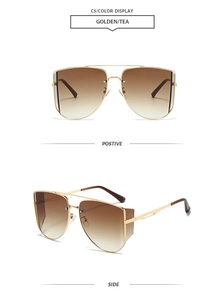 Detail view of double-bridge gold metal sunglasses with brown gradient lenses and side shields