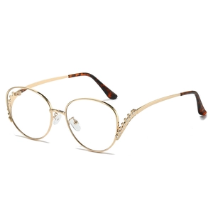 Oversized round gold metal sunglasses with rhinestone details and tortoiseshell tips
