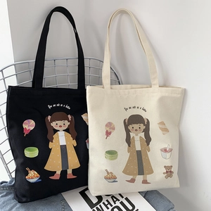 Detailed view of canvas tote bags with cute cartoon illustrations and slogan prints