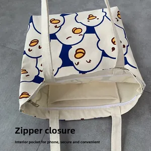 Detail of canvas tote bag showing secure zipper closure and internal phone pocket