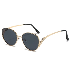 Oversized gold metal sunglasses with diamond-encrusted wave temples and dark lenses