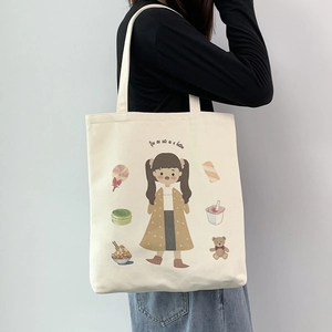 Off-white canvas tote bag with cute cartoon girl illustration and single shoulder strap