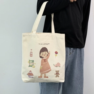 Detail of canvas tote bag showing cute cartoon girl illustration and English text print