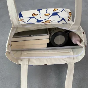 Interior view of large capacity canvas tote bag showing zipper pocket and spacious storage