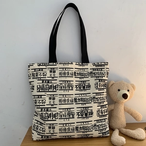 Large canvas tote bag with funny text prints and black handles for daily school use